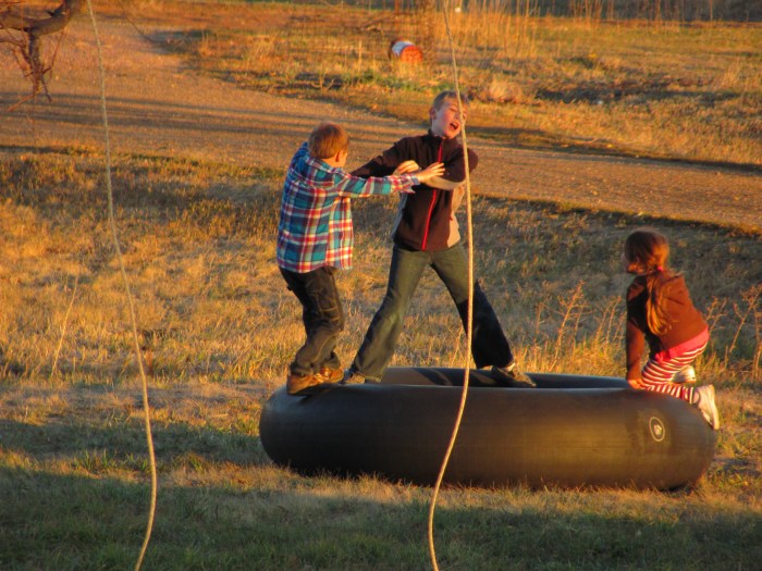 Small town fun:  Using a combine inner-tube as a trampoline.