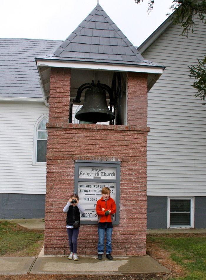In front of the bell tower.  Sonora - our budding journalist has here camera ready.